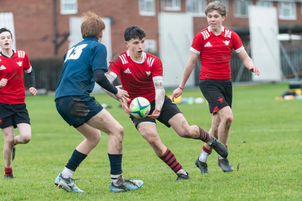 Pupils competing in a rugby match
