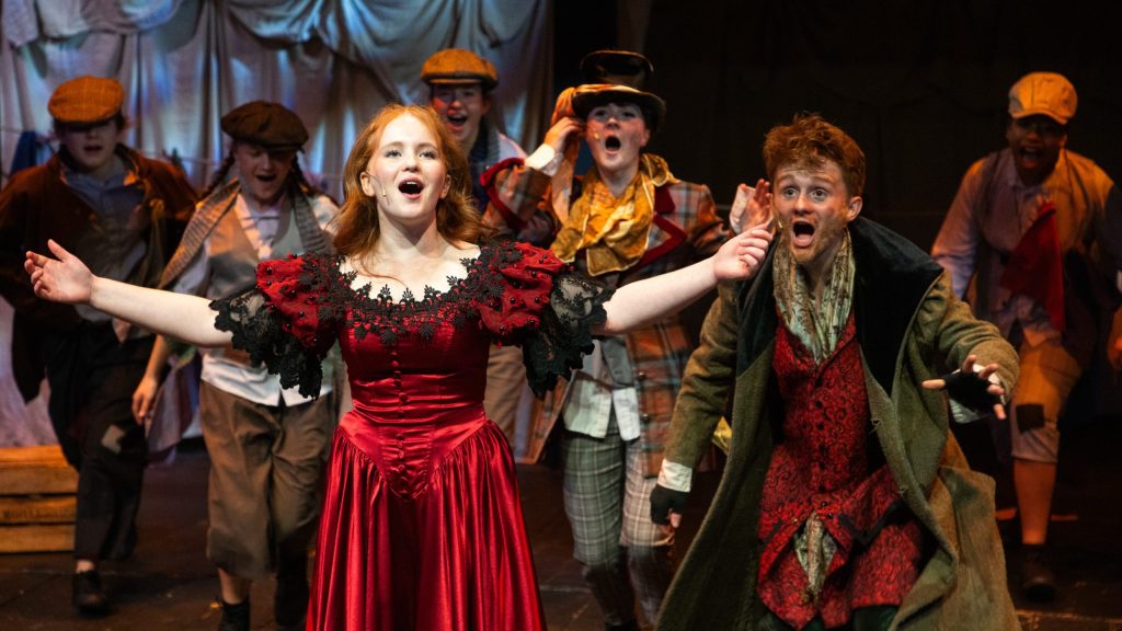 Pupils in costume performing in a school production